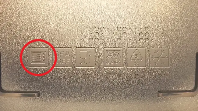 The bottom of a plastic container with a circled microwave safe symbol