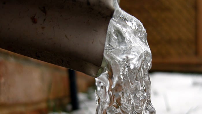 A close-up of the end of a frozen discharge pipe