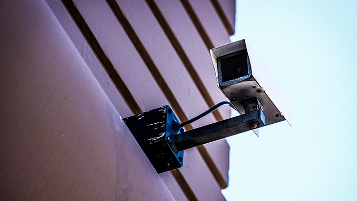 An outdoor security camera installed on the external wall of a building