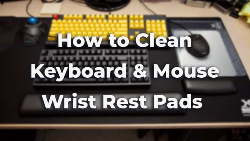 A keyboard and a mouse with keyboard and mouse wrist rest pads on a desk