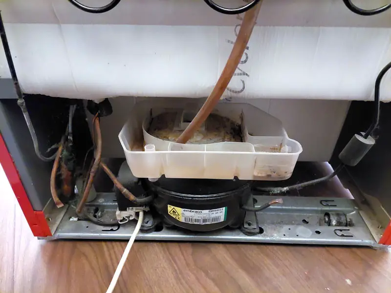 Refrigerator drip pan above the compressor at the bottom of a refrigerator 