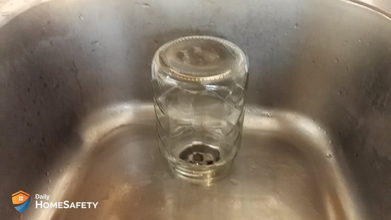 Jar over the drain to trap flies 