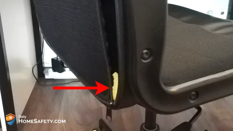 A black office chair with a note hidden under its cover