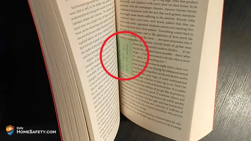 An open book with a note in red circle between two pages