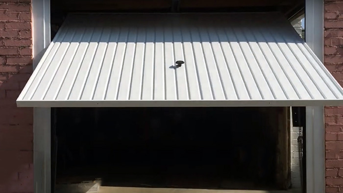 An open canopy tilt up garage door from the outside