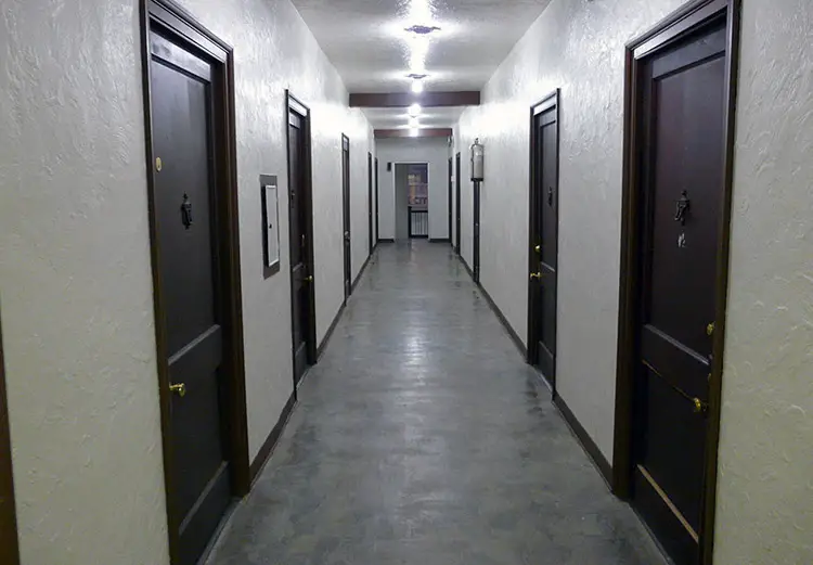 Condo hallway with several doors on both sides