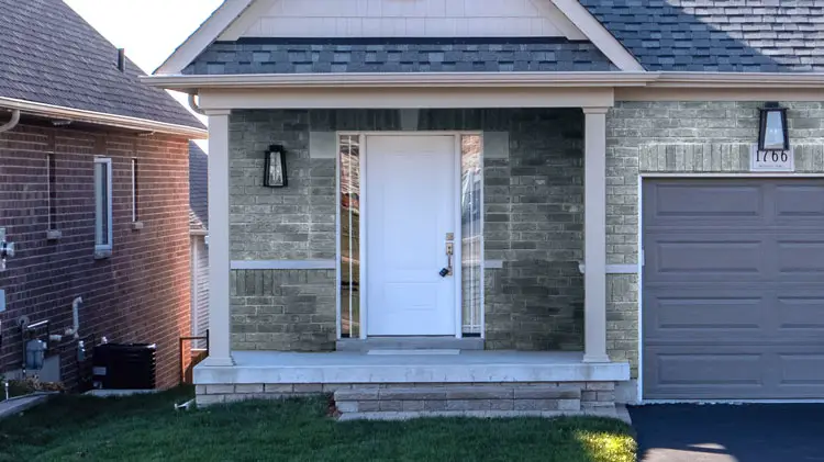 White front door with dark gray brick walls