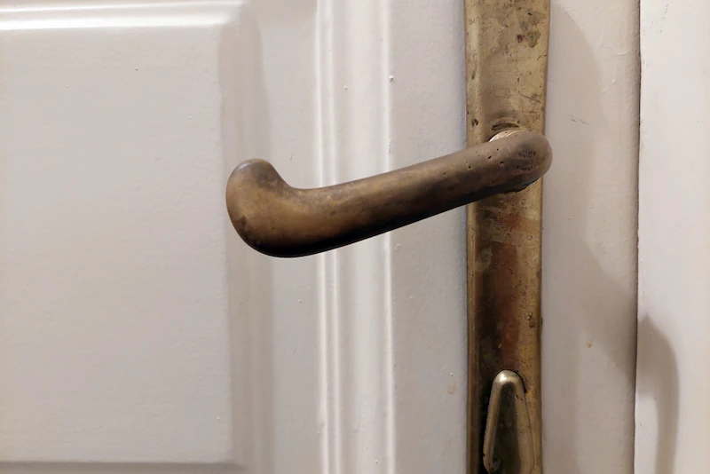 An antique brass door handle